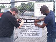 Photo of men installing a sign. Link to Gifts from Retirement Plans