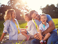 Photo of a family smiling and having fun. Link to Life Stage Gift Planner Under Age 45 Situations.