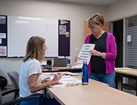 A women teaching another woman French. Links to Gifts by Estate Note